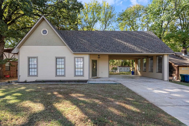 view of front of house with a front lawn and a carport