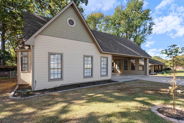 view of side of property with a patio and a yard