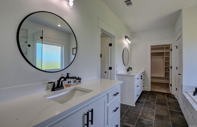 bathroom featuring shower with separate bathtub, tile patterned flooring, and vanity