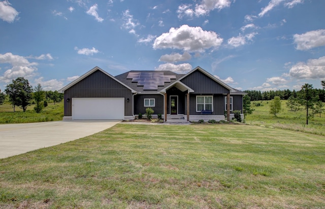 view of front of home featuring a front lawn, solar panels, and a garage