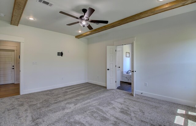 unfurnished room with carpet, beam ceiling, and ceiling fan