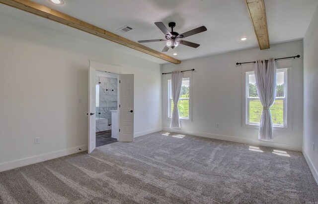 unfurnished bedroom with carpet, beam ceiling, ceiling fan, and ensuite bathroom