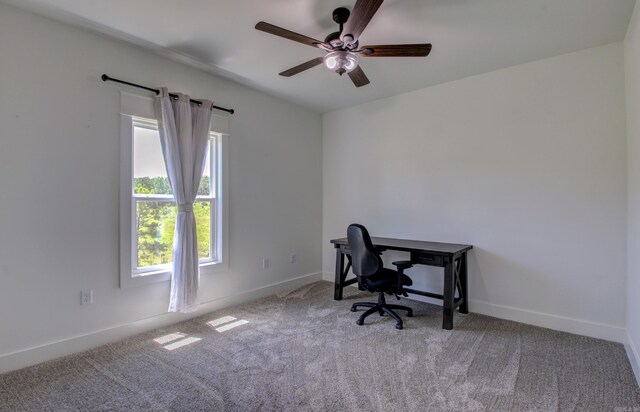 carpeted office featuring ceiling fan