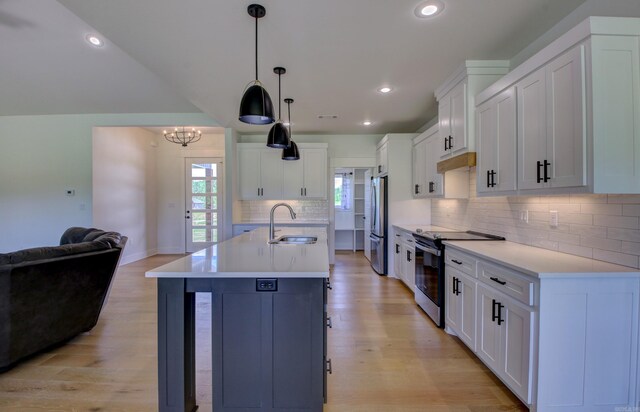 kitchen with white cabinets, appliances with stainless steel finishes, and sink