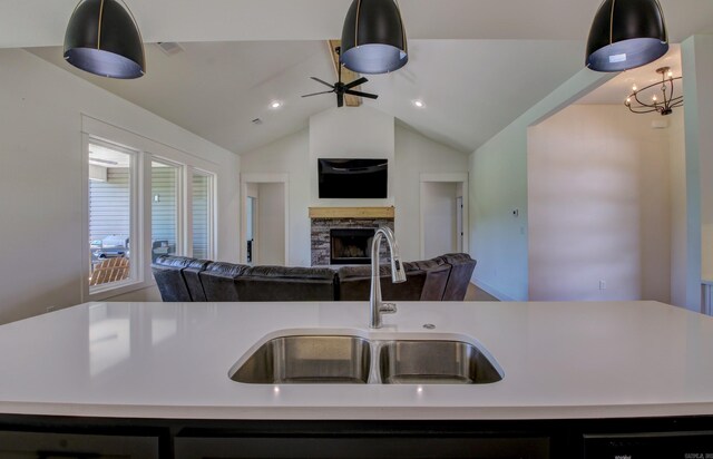 kitchen with a fireplace, sink, and an island with sink