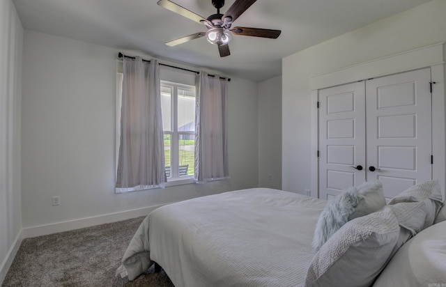 carpeted bedroom with ceiling fan and a closet