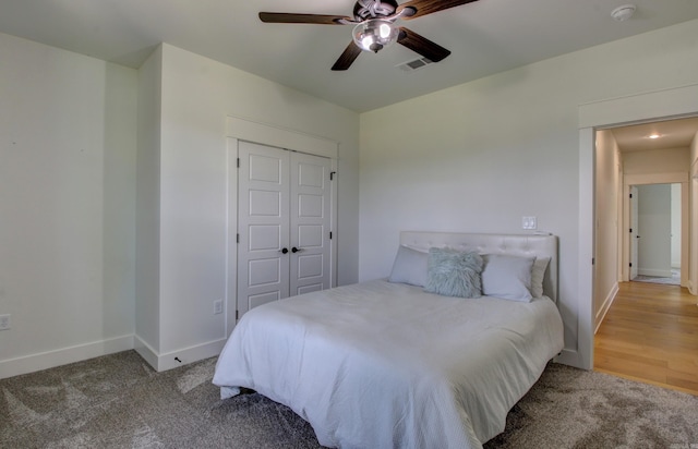 bedroom featuring hardwood / wood-style flooring, ceiling fan, and a closet