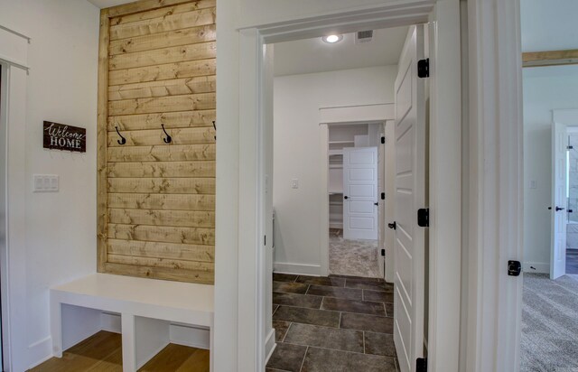 mudroom featuring dark tile patterned flooring