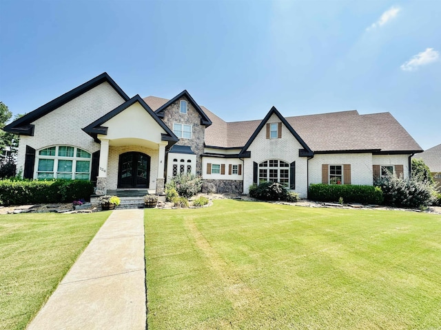 french country inspired facade featuring a front yard