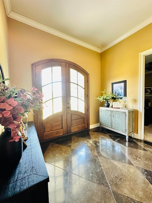 entrance foyer with crown molding and french doors