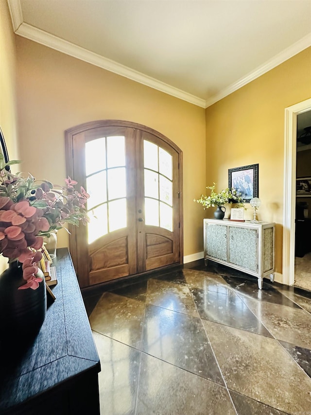 entrance foyer with crown molding and french doors