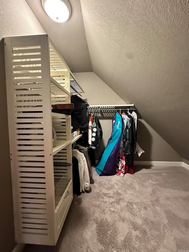 spacious closet featuring carpet floors and vaulted ceiling