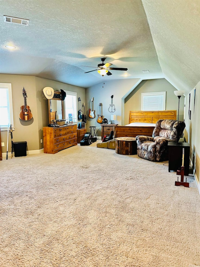 carpeted bedroom with a textured ceiling, vaulted ceiling, and ceiling fan