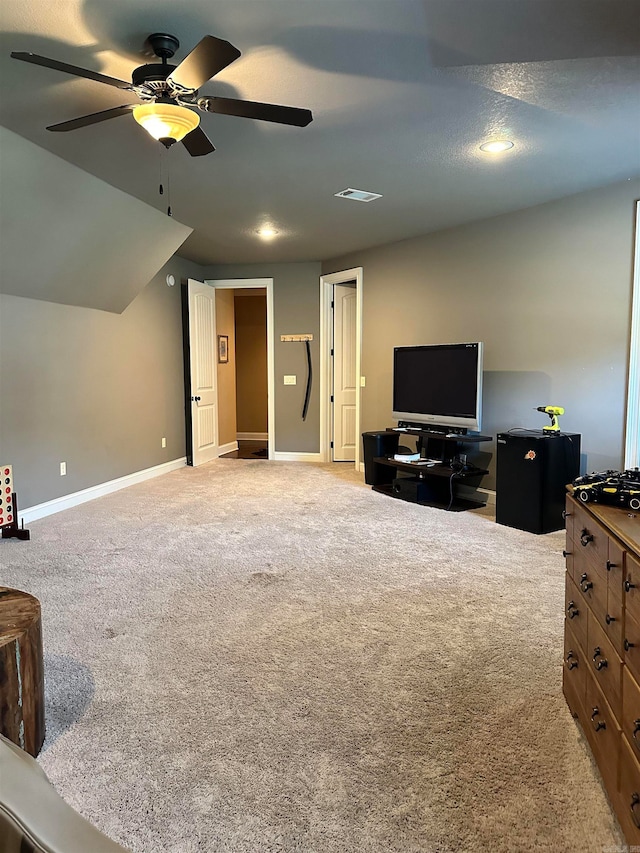 living room featuring ceiling fan, a textured ceiling, lofted ceiling, and carpet