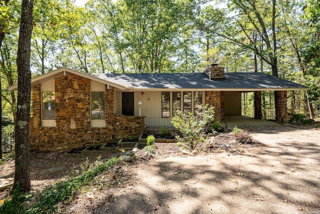 ranch-style home featuring a carport