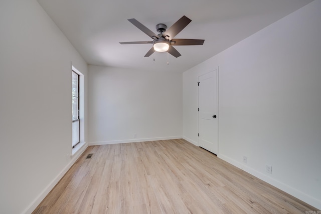 empty room featuring ceiling fan and light hardwood / wood-style flooring