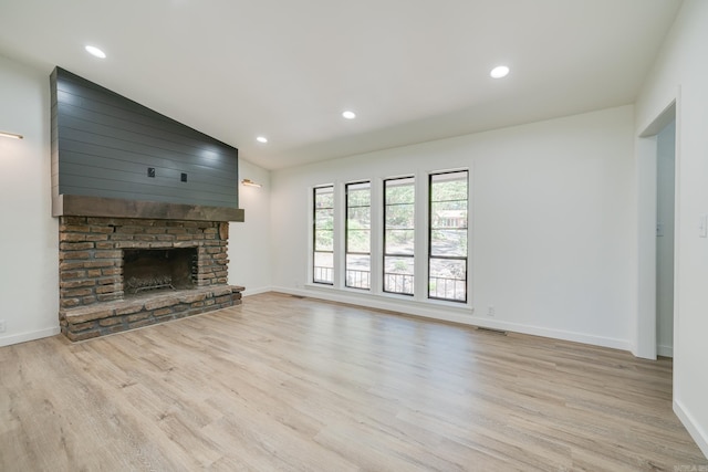 unfurnished living room featuring light wood-type flooring and lofted ceiling