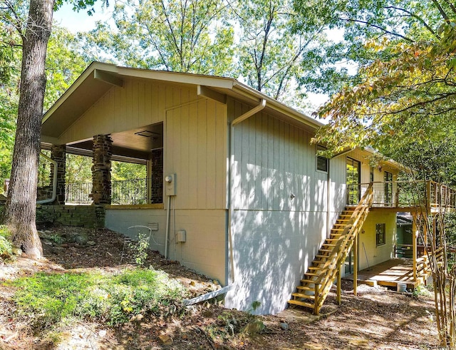 view of side of home with ceiling fan