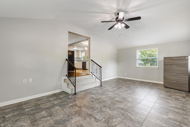 empty room featuring ceiling fan and vaulted ceiling