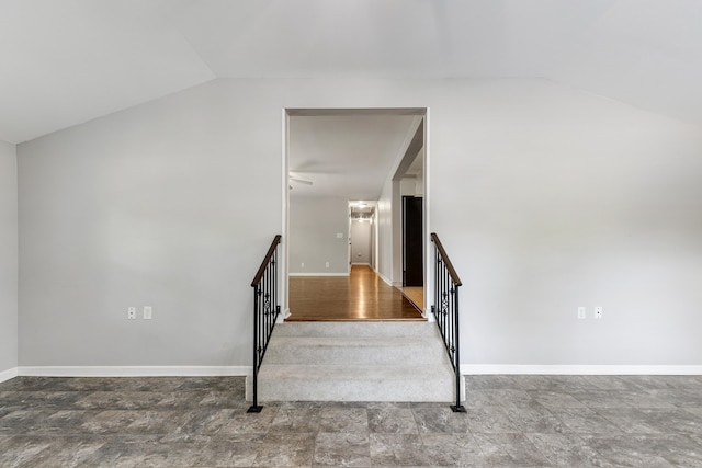 stairway featuring vaulted ceiling