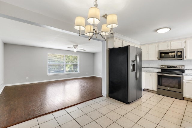 kitchen featuring light hardwood / wood-style floors, tasteful backsplash, white cabinets, stainless steel appliances, and decorative light fixtures