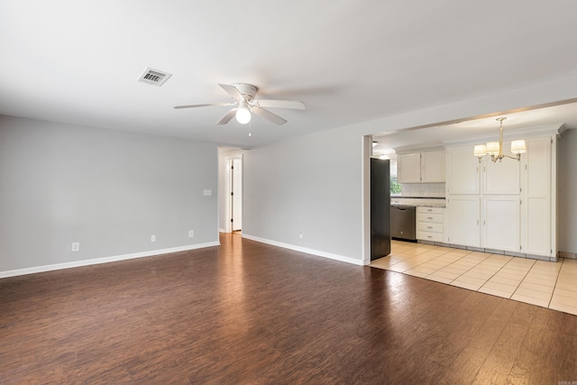 unfurnished living room with light wood-type flooring and ceiling fan with notable chandelier