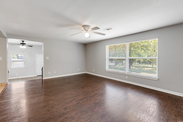 empty room with ceiling fan and dark hardwood / wood-style floors