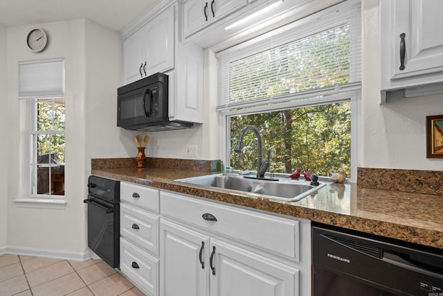 kitchen featuring light tile patterned flooring, white cabinets, black appliances, dark countertops, and a sink