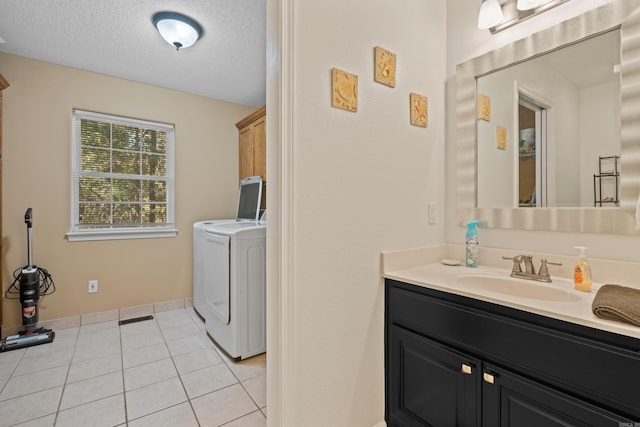 bathroom featuring washer / clothes dryer, a textured ceiling, vanity, tile patterned flooring, and visible vents