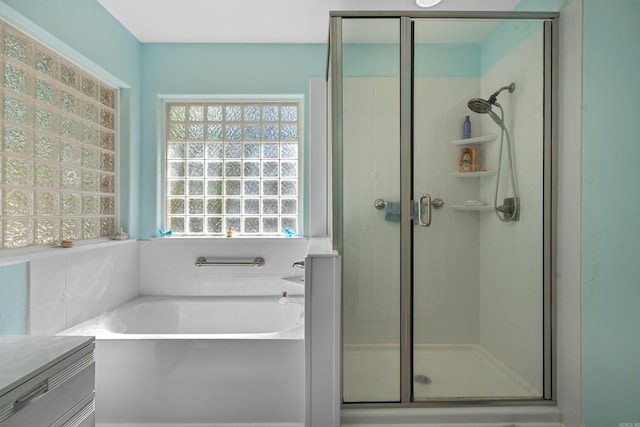 full bath featuring a bath and a stall shower