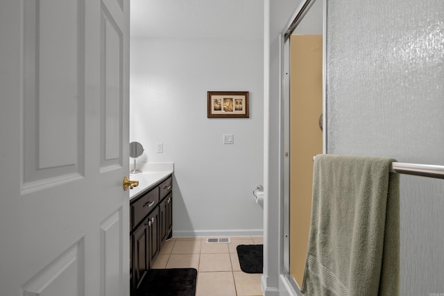 full bath with a shower with door, tile patterned floors, vanity, and visible vents