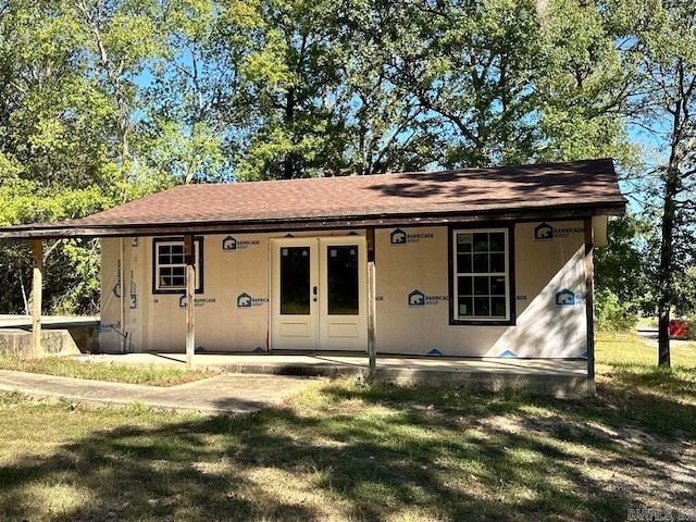 exterior space with a front yard and french doors