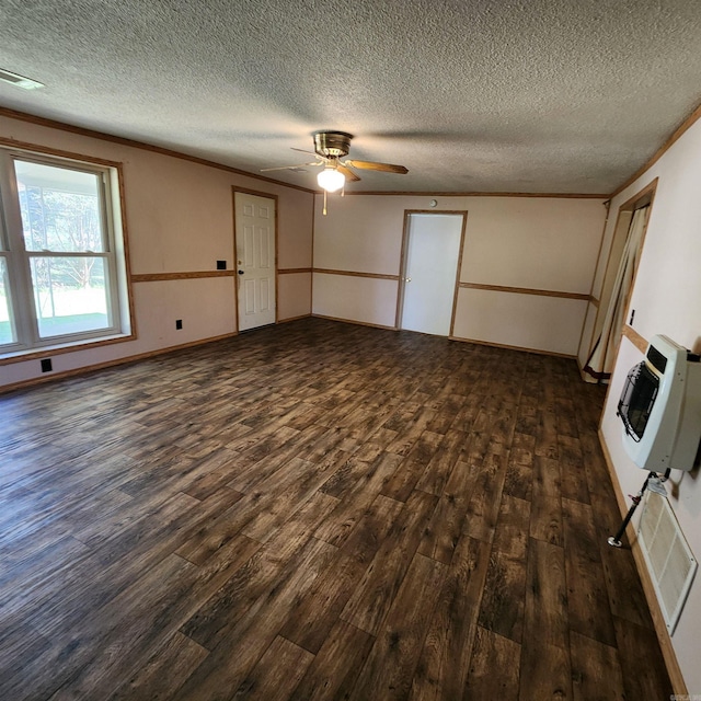 unfurnished living room with heating unit, a textured ceiling, dark wood-type flooring, and ceiling fan