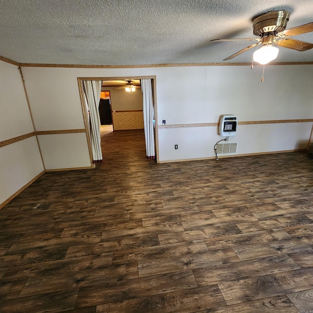 spare room with heating unit, a textured ceiling, dark hardwood / wood-style floors, and ceiling fan