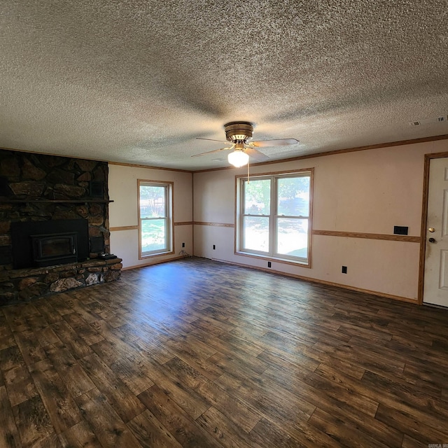 unfurnished living room with a textured ceiling, ornamental molding, dark hardwood / wood-style floors, and ceiling fan