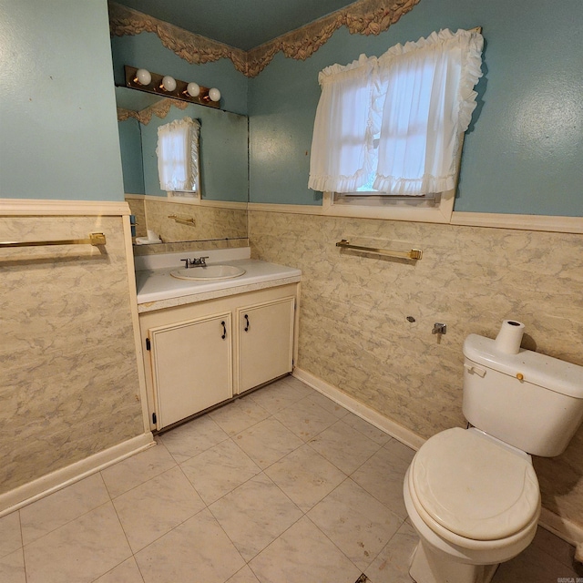 bathroom with vanity, tile walls, toilet, and tile patterned floors