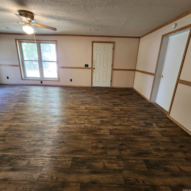 spare room with a textured ceiling, dark hardwood / wood-style flooring, and ceiling fan