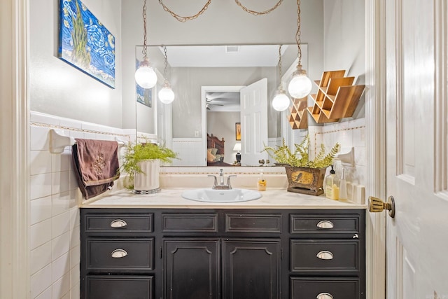 bathroom with tile walls and vanity