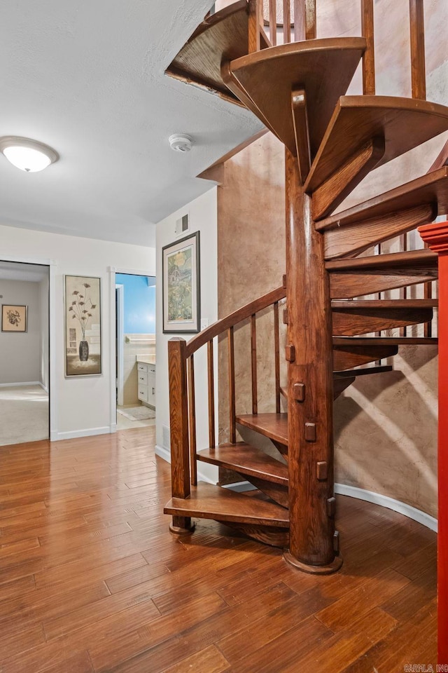 stairway featuring wood-type flooring