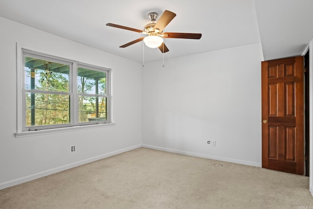 carpeted spare room with ceiling fan