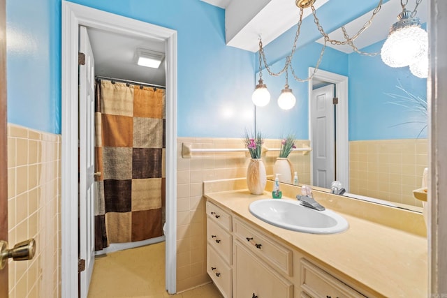 bathroom with vanity, toilet, a shower with curtain, tile walls, and tile patterned flooring