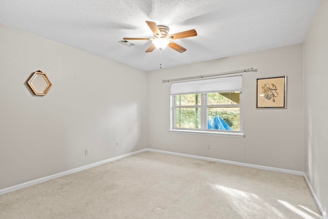 spare room with light carpet, a textured ceiling, and ceiling fan