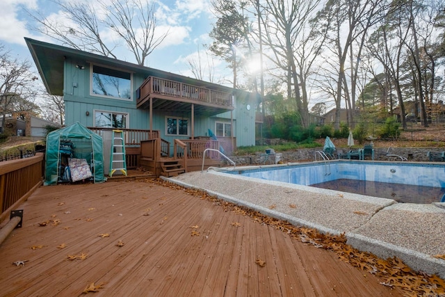 view of swimming pool with a wooden deck