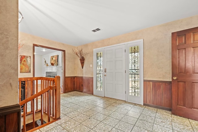 entrance foyer featuring wood walls