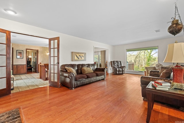 living room featuring light hardwood / wood-style flooring and french doors