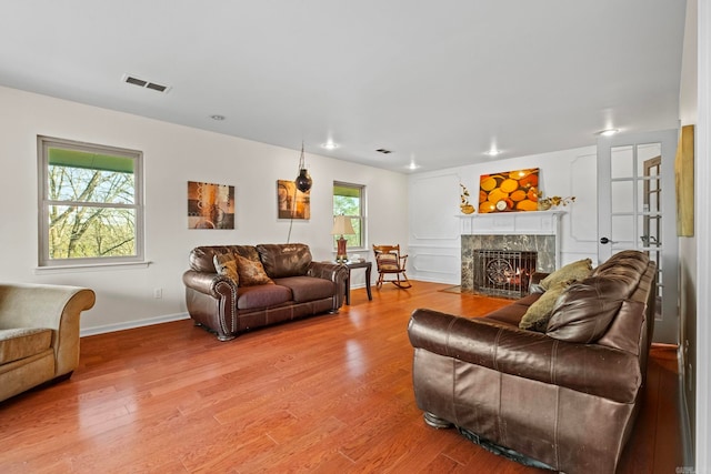 living room featuring light hardwood / wood-style floors and a wealth of natural light