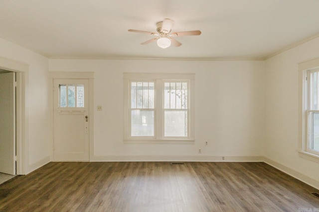 interior space with ornamental molding, ceiling fan, and dark wood-type flooring