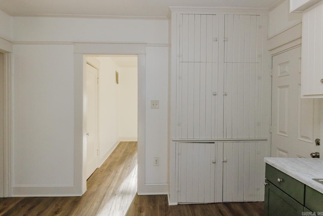 bathroom with ornamental molding, hardwood / wood-style flooring, and vanity