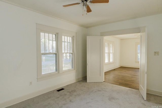 unfurnished room with crown molding, light hardwood / wood-style floors, and ceiling fan