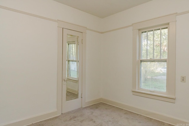 unfurnished room featuring light colored carpet